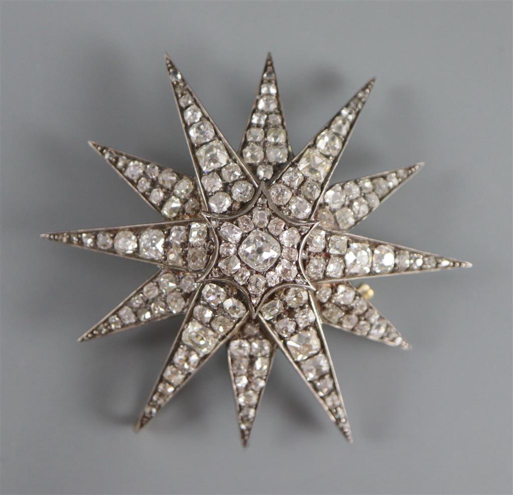 A Victorian gold, silver and graduated old round and cushion cut diamond set starburst pendant brooch,